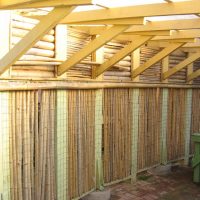 Ray Newkirk General Contractor: Bamboo redwood corrugated fiberglass 2 car center wall carport